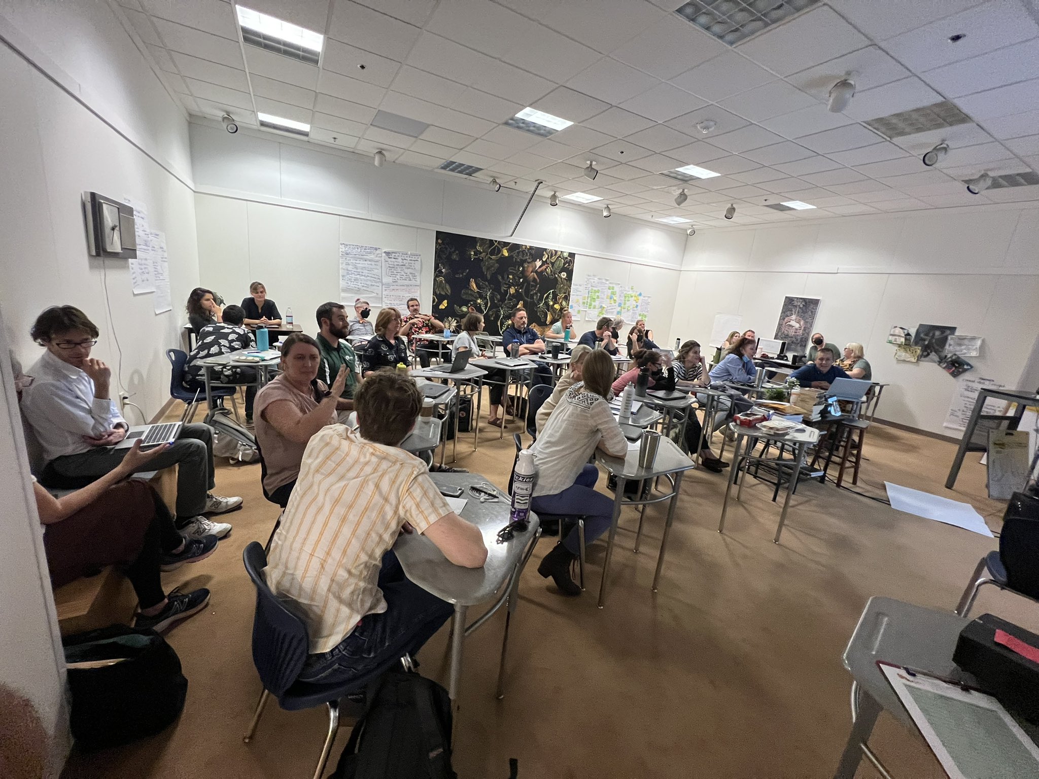 A workshop with educators discussing topics in small groups.